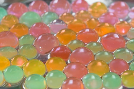 Background with transparent colored beads closeupの写真素材