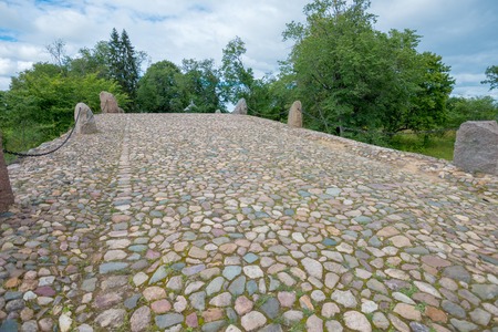 Hundred-meter boulder-arch bridge with two grotto - aviary, called by locals "Devil's Bridge." Consisting of dry stacked boulders, kept only by gravityの写真素材