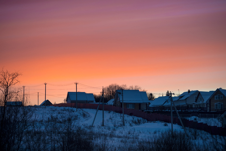 Winter bright sunset in the villageの写真素材