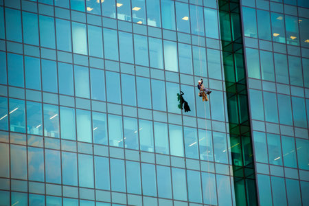 MOSCOW- APRIL 25, 2016:Window cleaners at work on the fortieth floor heightのeditorial素材