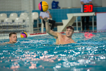 MOSCOW - NOVEMBER 18, 2016: Katkov Pavel in action at a Russia national championship water-polo game between Dynamo-Moscow (white) vs STORM-2002 (black) Dynamo won 10-6のeditorial素材