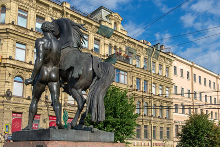 RUSSIA, SAINT PETERSBURG - AUGUST 18, 2017: Famous sculpture "Horse walking with a young man" on Anichkov Bridge across the Fontanka River, designed by the Russian sculptor Baron Peter Klodtのeditorial素材