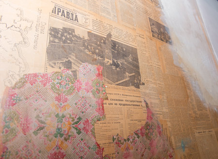RUSSIA, SAINT PETERSBURG - AUGUST 18, 2017: Fragment of an old wall with ragged wallpaper and old communist newspapersのeditorial素材