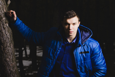 cool guy in forest look at youの写真素材