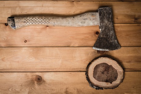 The composition of ax and chopped the barrel with rings on the wooden tableの写真素材
