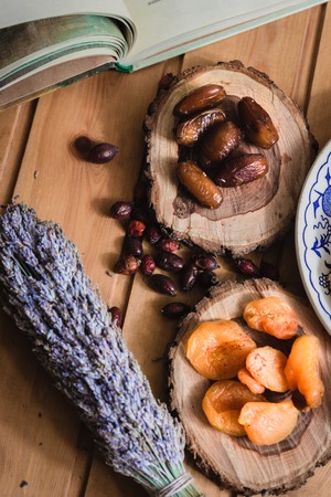 composition from book with fairy tale and dried fruits on wooden platesの写真素材