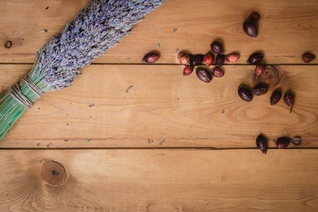 bundle of dried lavender and rosehip berries on a wooden table