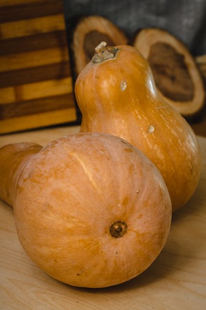 Two pumpkins on wooden table. front viewの写真素材