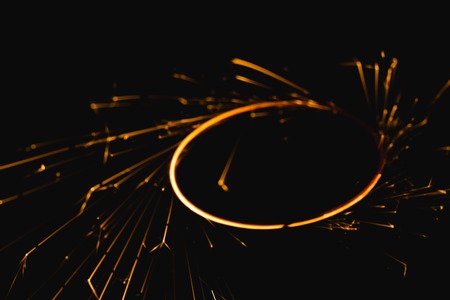 Radial trail of sparks that glow in the darkの写真素材