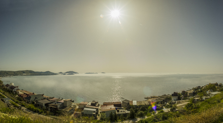 landscape panorama of sea bay with little houses along the coast.の写真素材