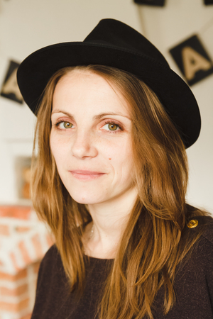 Beautiful woman in brown hatの写真素材