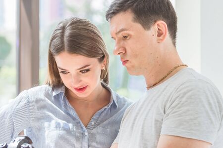 young man shows a young woman a cameraの写真素材