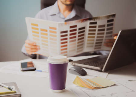 The idea of getting a creative education. A person selects an item from the catalog. Laptop and...