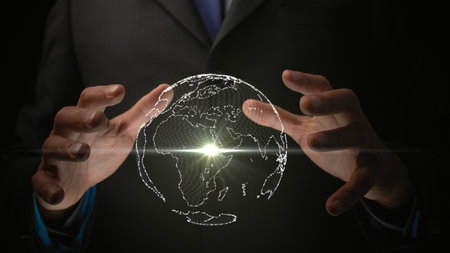 From a single point of light, a globe emerges within the illuminated hands of a person. Cg.の写真素材
