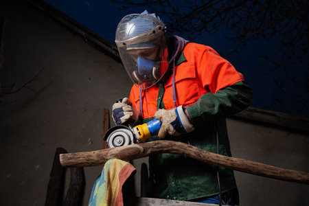 A man at work processing wood. The process of making the musical instrument Digiridoo. Hobby....