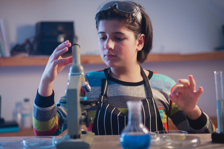 Modern educational program including practical classes. A young chemist in a home research...