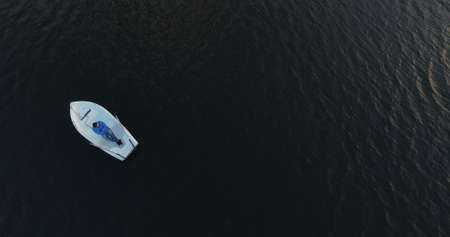 Aerial view, vacation, man ride in white boat on lakeの写真素材