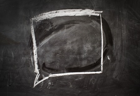 Comics speech bubble drawn on the black chalkboard.の写真素材