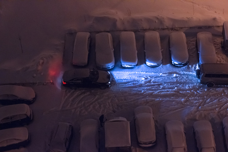 Car parking in snow at nightの写真素材
