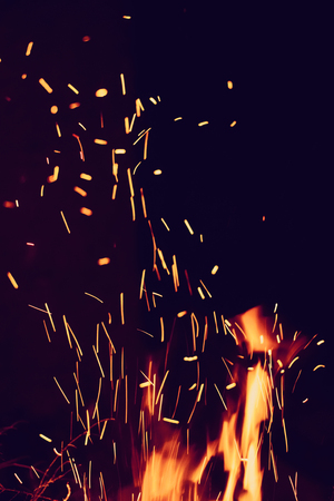 Night bonfire with sparks. Fire background with copyspaceの写真素材