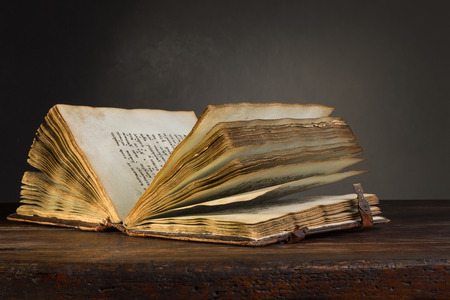 Old open book on a tableの写真素材