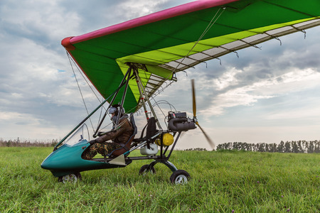 Powered paragliding at the flying field with green grass.の写真素材