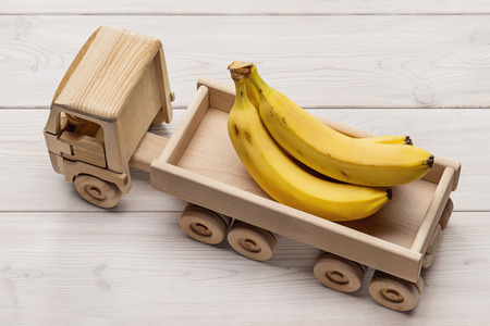 Bananas in trailer truck, toy made of wood.の写真素材