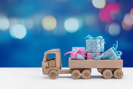 holiday boxes in blue with white polka dots and pink packaging at the back of a toy car.の写真素材