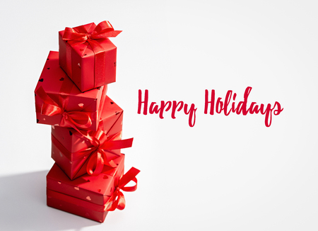 Happy holidays. Set of vertically arranged red boxes with gifts.の写真素材