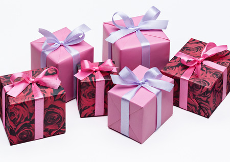 Set of bright colorful gift boxes with ribbons on white background. Copy space for text.