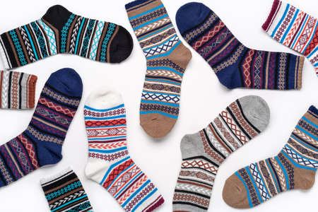 Concept background of colorful pile socks. Beautiful new unisex stretch sports socks isolated on...