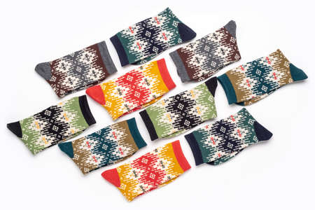 Multicolored knitted socks with ornaments, cute gift. Close-up of colorful soft socks for comfort...