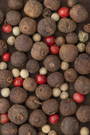 Dry peas of allspice and hot peppers of different colors and sizes. Background and wallpaper,...