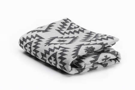 Luxurious Christmas gift, woolen throw blanket in Pendelton style on a white background.