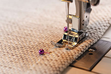 Electric sewing machine. Detail of a needle, plate, foot on the fabric, ready to work.の写真素材