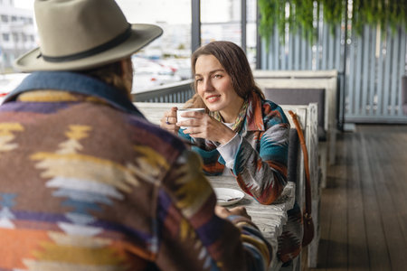 Happy woman in a hat, holding a ukulele, on a golden grain field in autumn.の写真素材