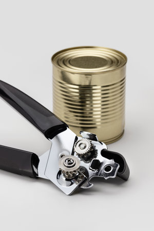 Kitchen utensils. Modern can opener, tin can. Close-up, copy space.の写真素材