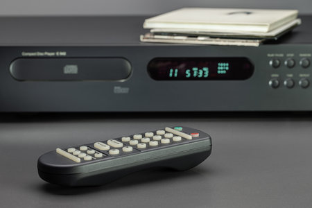 CD player and sound control panel, close-up. Discs in envelopes on the cover of the player.の写真素材