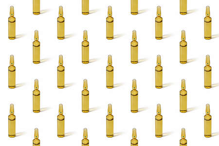 Vertical ampoules with medicines. Close-up, vaccination concept. Pattern, template, wallpaper, on white.の写真素材