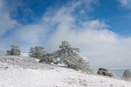 Off-road car on winter landscapeの写真素材