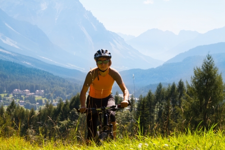 Mountain biking - woman on bike, Dolomites, Italyの写真素材