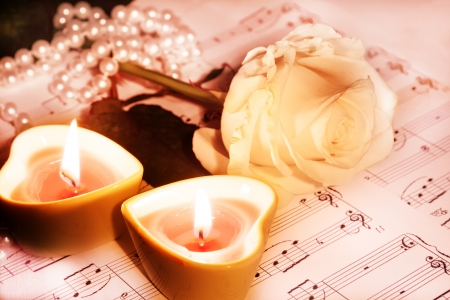 beautiful rose, and two candles in the shape of heartの写真素材