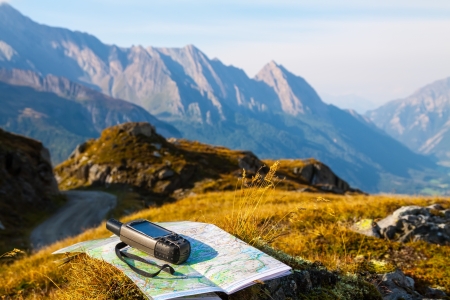 GPS navigator and map on Alps mountain backgroundの写真素材