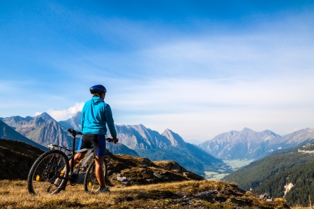 Mountain biking - woman on bike, Dolomites, Italyの写真素材
