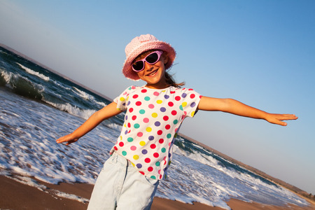 happy small girl outdoors on the beachの写真素材