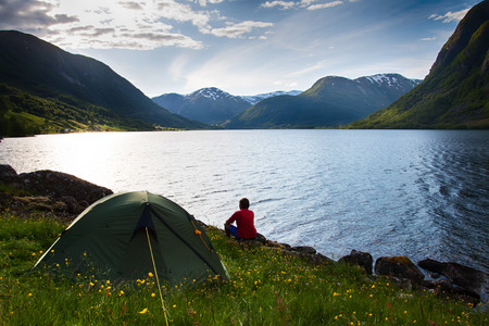 woomen sitting  near lake in mountains, Norwayの写真素材