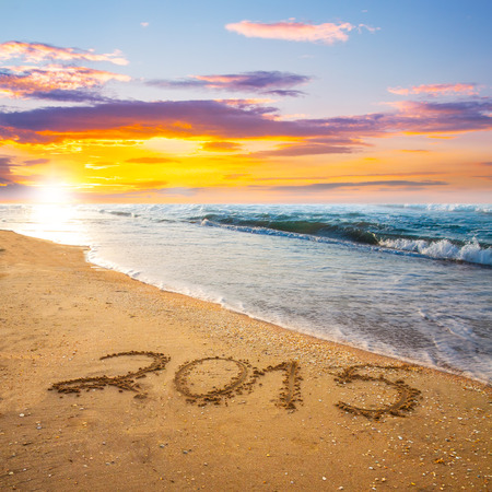 new year 2015digits on ocean beach sandの写真素材