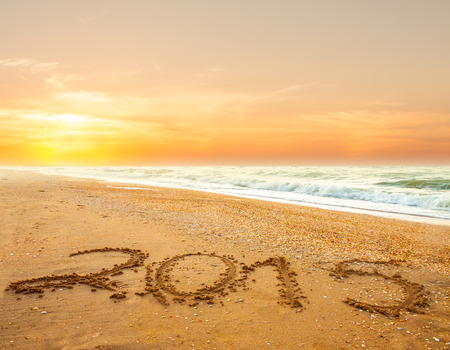 new year 2015 digits on ocean beach sandの写真素材