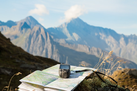 GPS navigator and map on Alps mountain backgroundの写真素材
