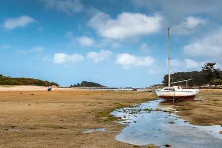 old boat  on beach in Brittany in low tideの写真素材